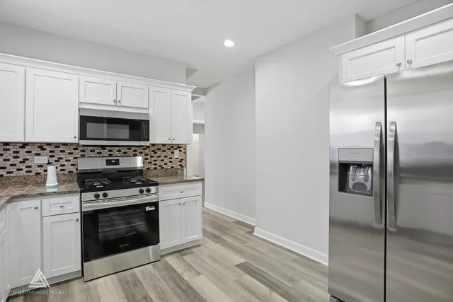 a kitchen with a stove and a refrigerator