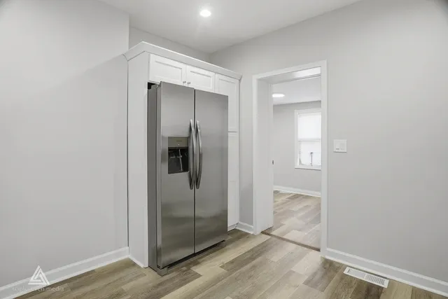a bathroom with a glass shower door and a mirror