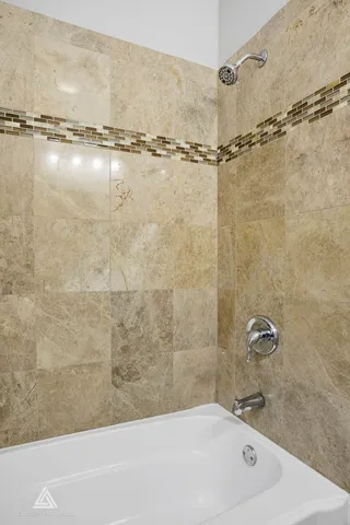 a bathroom with a bathtub and a shower