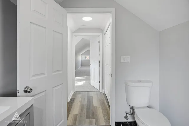 a bathroom with a granite countertop toilet sink and shower