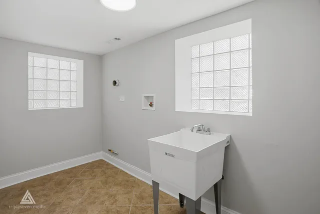 a bathroom with a sink a mirror and a window