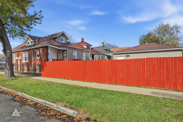a view of a house with a yard and a garden