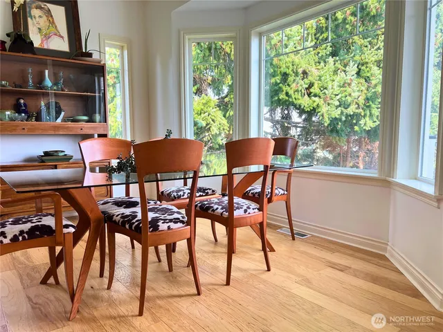 a dining room with furniture and a window
