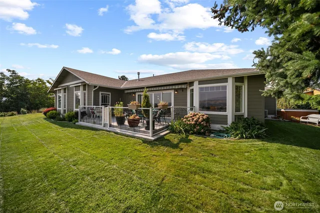 a view of a house with backyard porch and sitting area