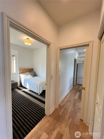 a bedroom with a bed and wooden floor