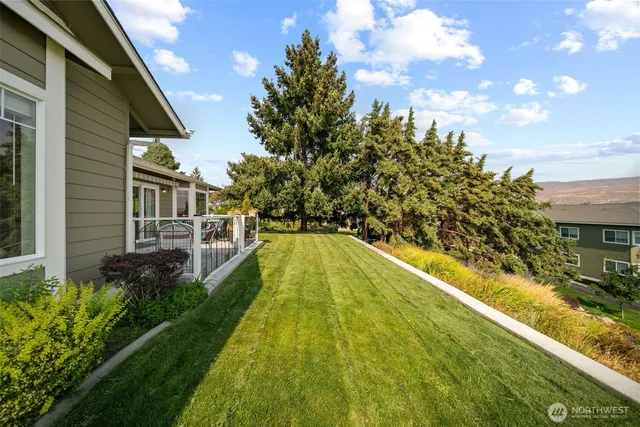 a view of a backyard with seating area
