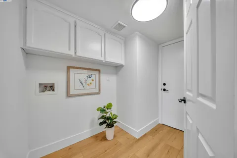 a bedroom with bed and a large window