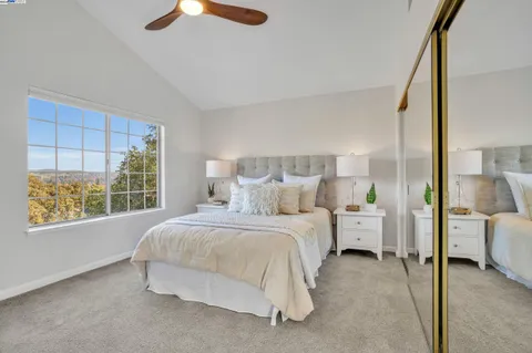 a bedroom with a large bed and a dresser