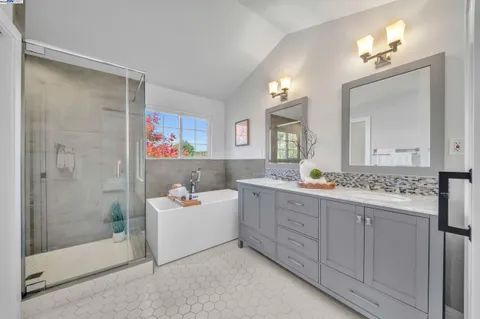 a bedroom with a bed and painting on the wall