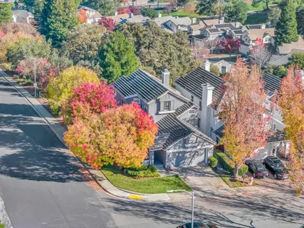 an aerial view of a house with a yard