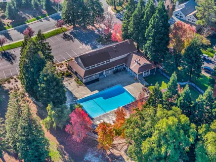 a view of a roof deck with table and chairs and wooden floor