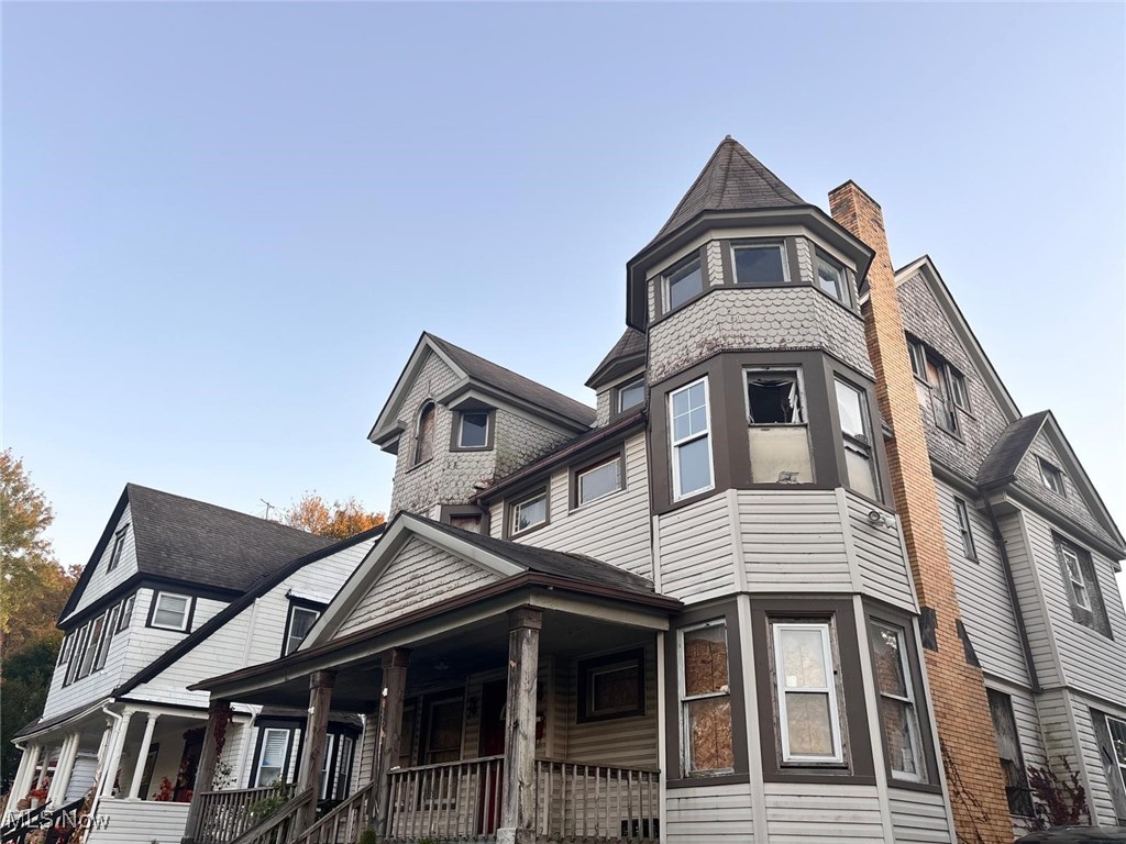 1888 Beersford Road Cleveland, OH 44112 - Photo 2 of 22 View of side of property with a porch and a chimney