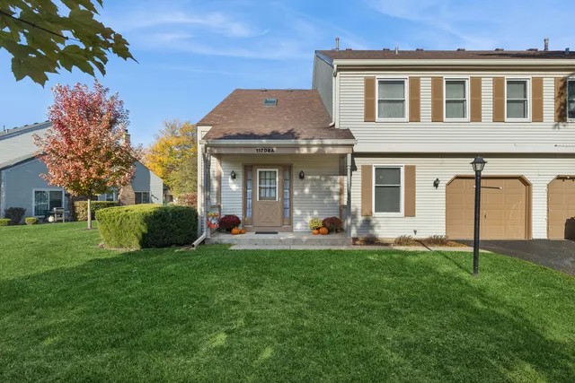 a front view of a house with a yard and porch