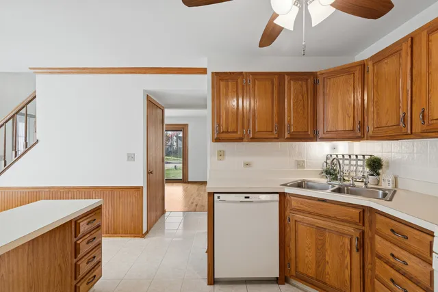 a view of a room with entryway window and a ceiling fan