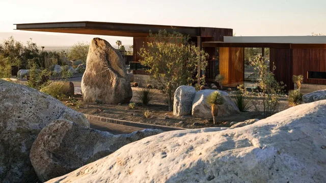 a view of a living room with furniture and floor to ceiling window