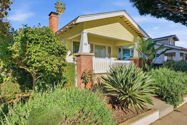 front view of a house with potted plants