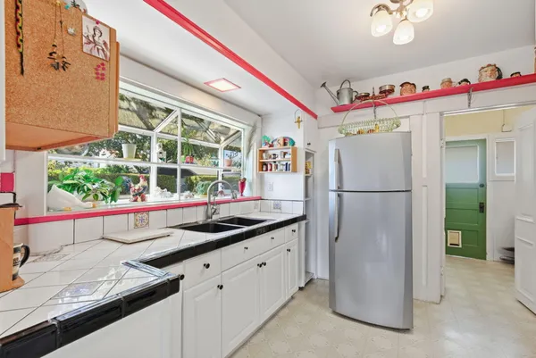 a kitchen with refrigerator and window