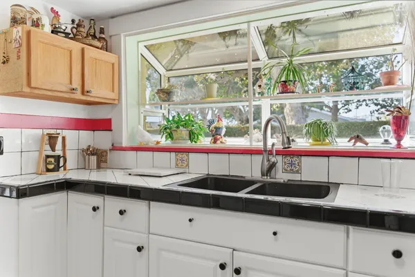 a kitchen with granite countertop a sink and a window