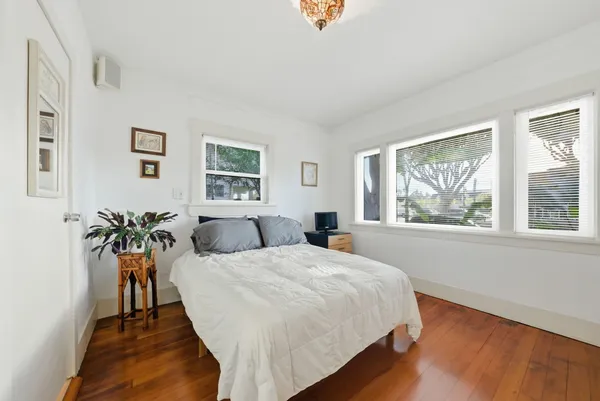 a bed sitting in a bedroom next to a window