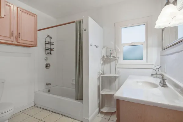 a bathroom with a sink a toilet and bathtub