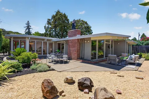 a view of a backyard with sitting area