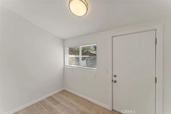 a view of a kitchen with white cabinets and white appliances