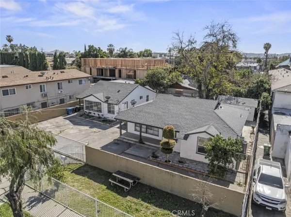 an aerial view of residential houses with outdoor space