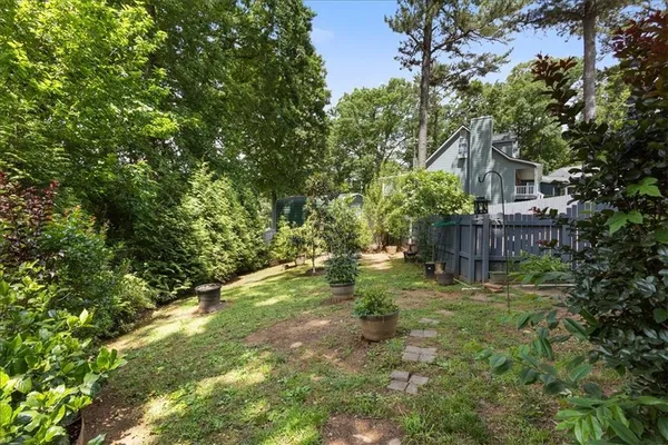 a backyard of a house with table and chairs