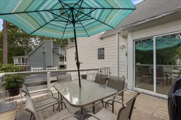 a patio with a table and chairs under an umbrella