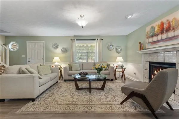 a living room with furniture a rug and a fireplace