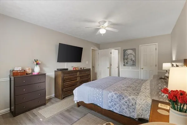 a bedroom with a bed and flat screen tv