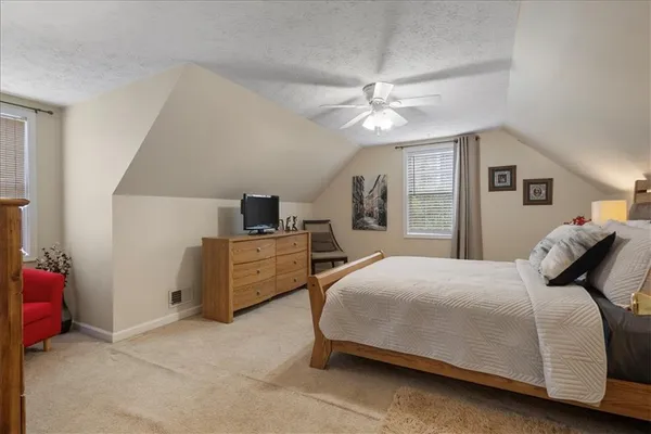 a bedroom with a bed and ceiling fan