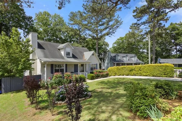 a front view of house with yard and green space
