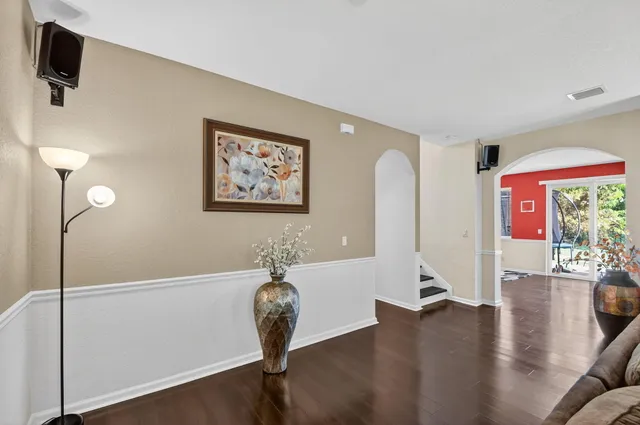 a kitchen with stainless steel appliances a dining table chairs stove and refrigerator