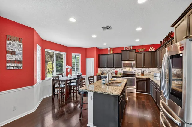 a view of a dining room with furniture and window