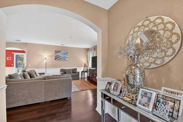 a living room with furniture and a chandelier