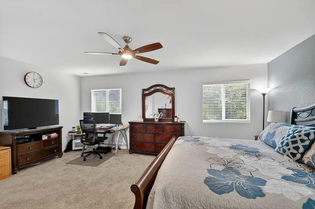 a view of a livingroom with workspace and a window