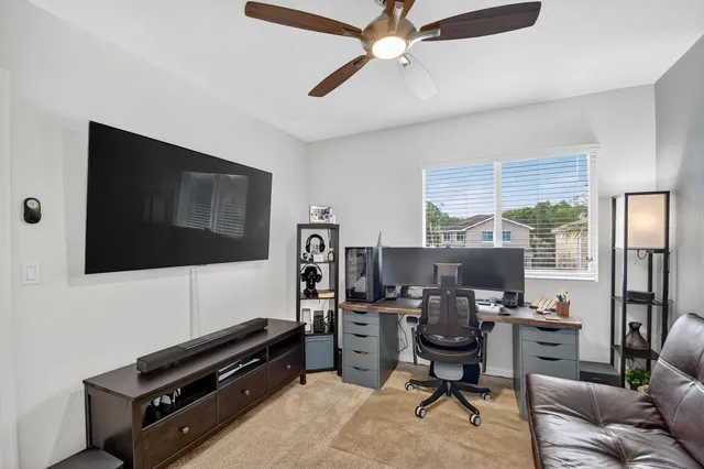 a view of a house with backyard and sitting area