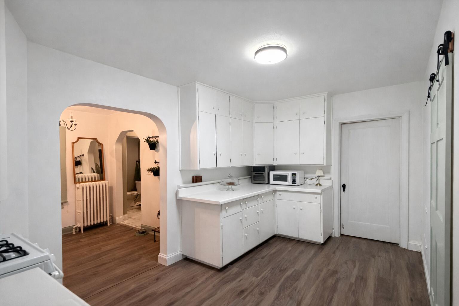 2619 Riverside Drive Lake Station, IN 46405 - Photo 11 of 21 a room with stainless steel appliances kitchen island wooden floors and white cabinets