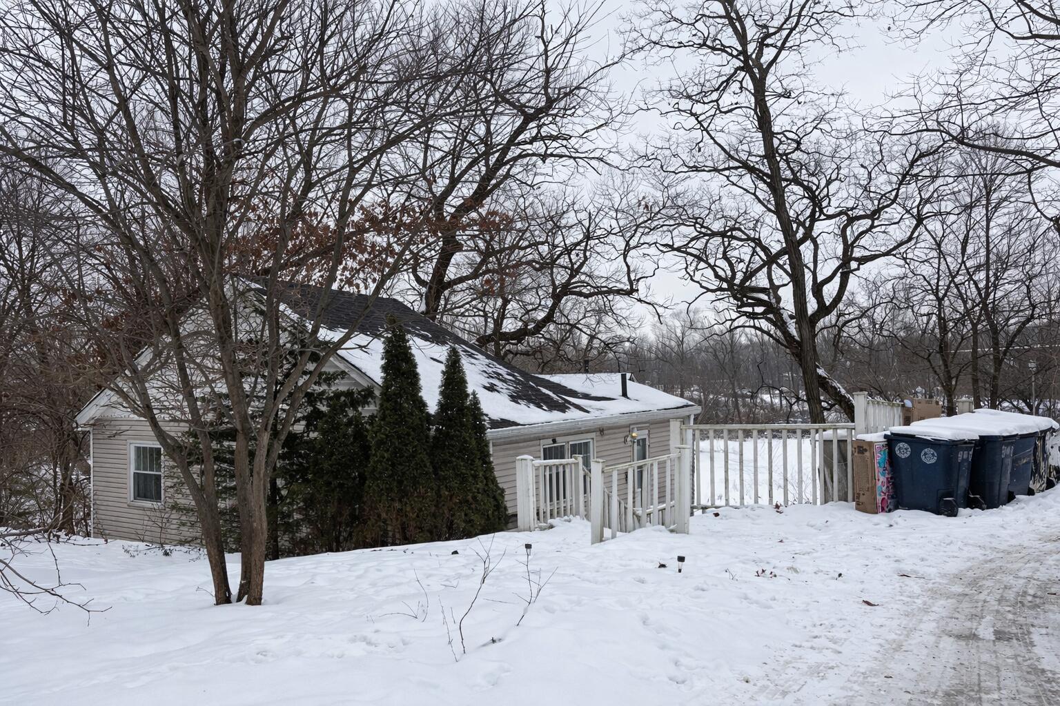 2619 Riverside Drive Lake Station, IN 46405 - Photo 20 of 21 a view of white house with a yard covered in snow