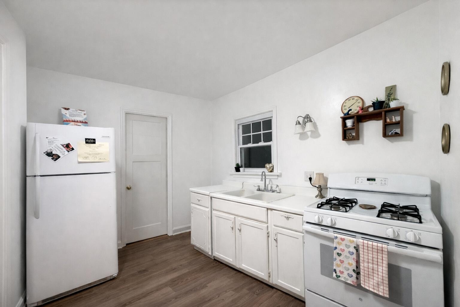 2619 Riverside Drive Lake Station, IN 46405 - Photo 10 of 21 a kitchen with a refrigerator a stove a sink and wooden floor