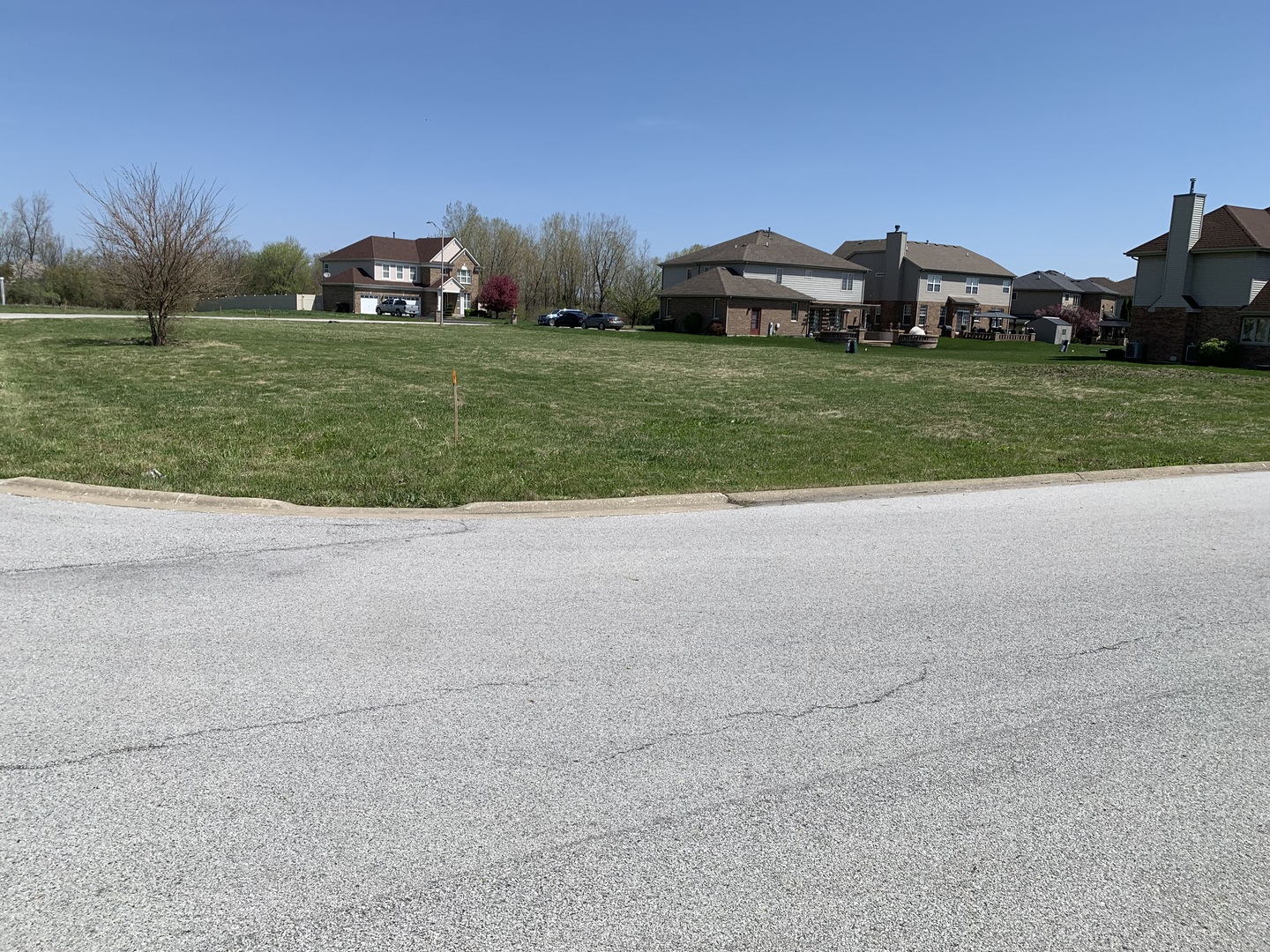 a view of a house with a yard and a car parked