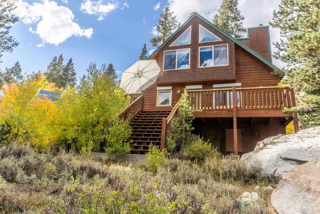 a view of a house with a yard and balcony