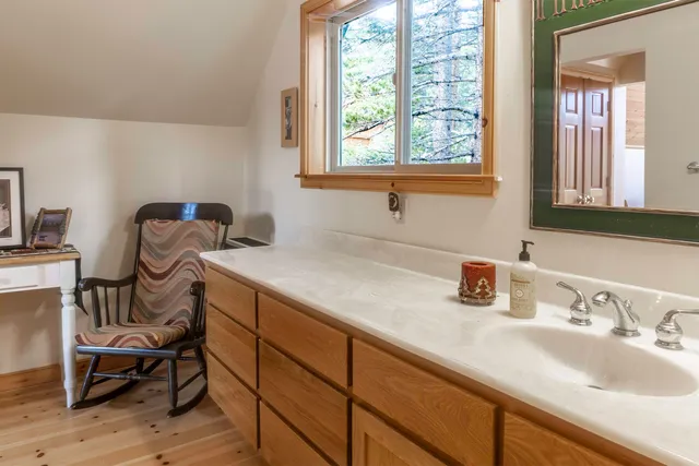 a bathroom with a sink and a window