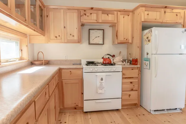 a kitchen with cabinets appliances a sink and a counter space