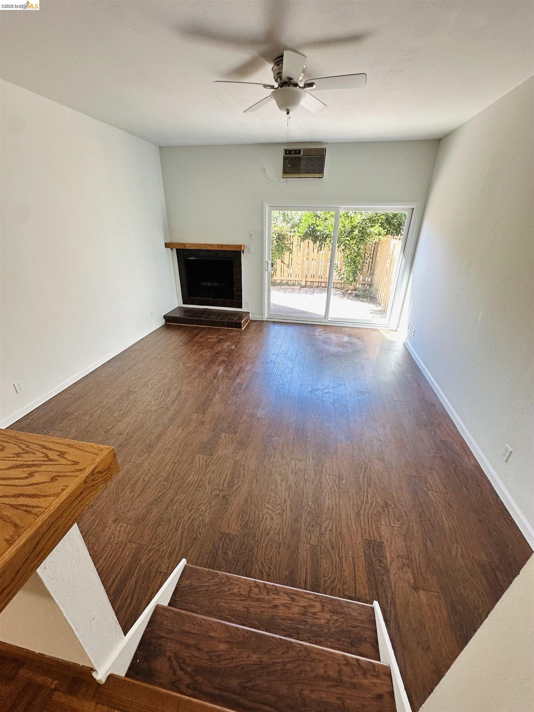9005 Alcosta Boulevard, Unit 189 San Ramon, CA 94583 - Photo 14 of 20 Unfurnished living room with dark wood-type flooring, a fireplace, and ceiling fan