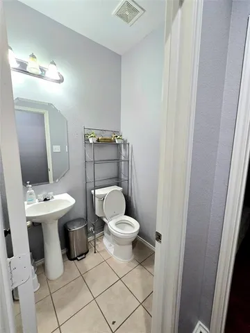 a white toilet sitting next to a bathroom sink