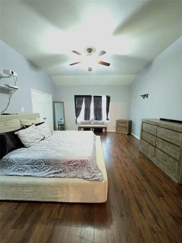 a living room with hard wood flooring and a couch