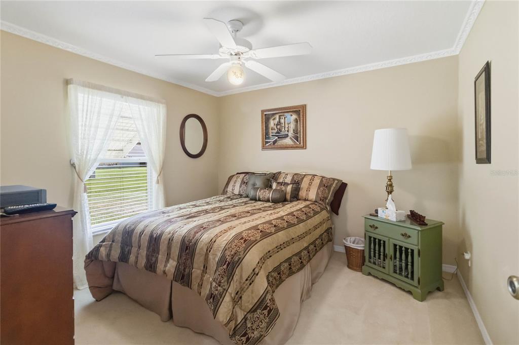 3225 Canoe Creek Road St. Cloud, FL 34772 - Photo 17 of 30 a bedroom with a bed and a chandelier