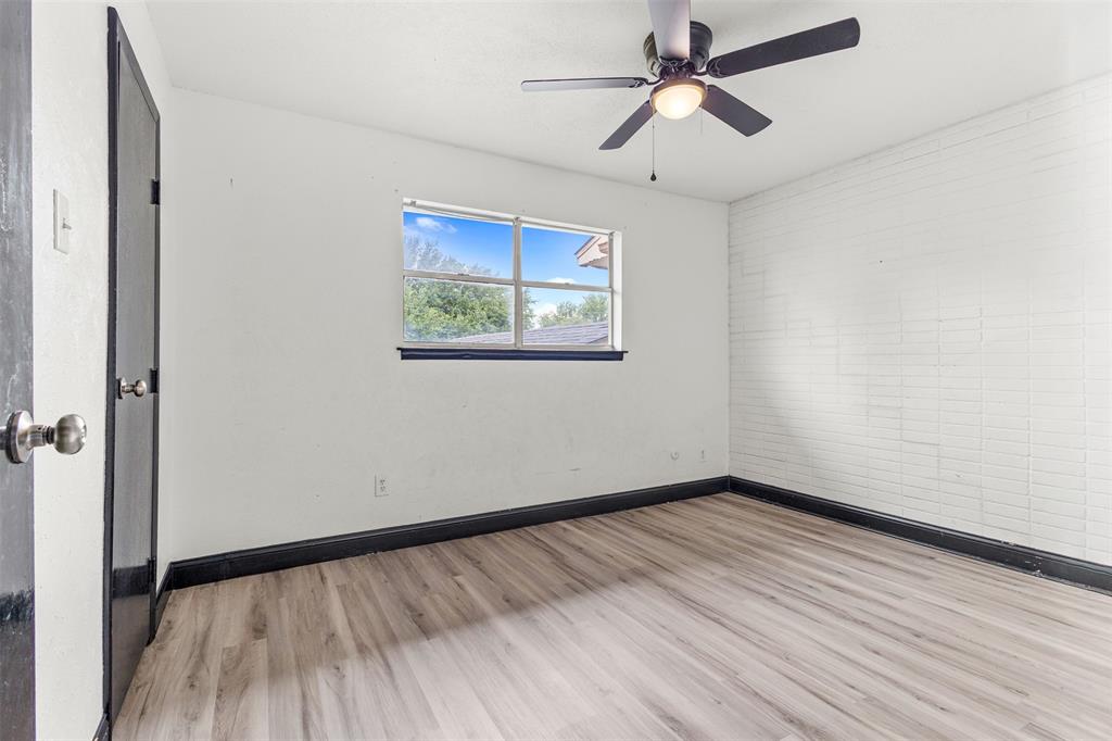 2802 Spring Valley Drive Bedford, TX 76021 - Photo 20 of 24 wooden floor in an empty room with a window